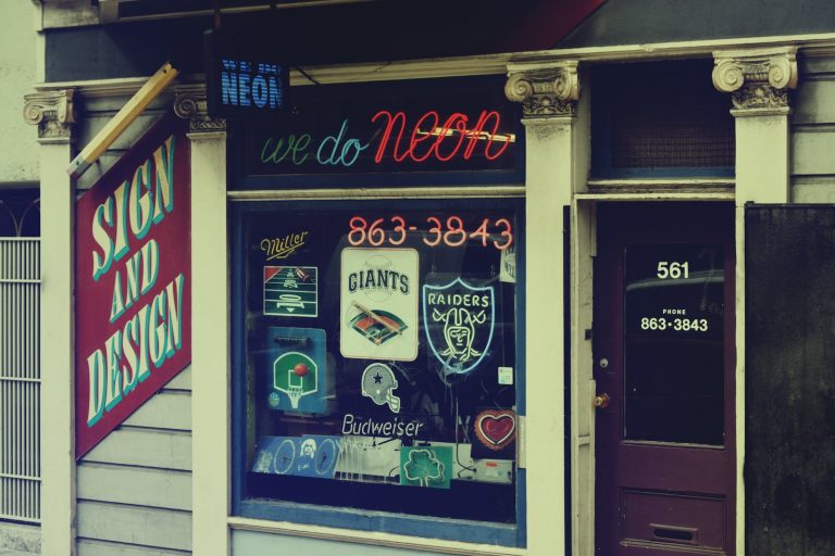 Window of a Store with Neon Signs
